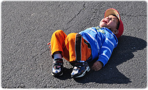 child throwing tantrum on floor